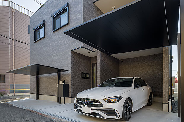 【【外観写真】 】カースペースは1台駐車可能(車種による)。屋根付きで、雨の日なども車の乗降がしやすいです。前面道路と敷地の境に段差がないため、車や自転車の出し入れもスムーズに行えそうです。