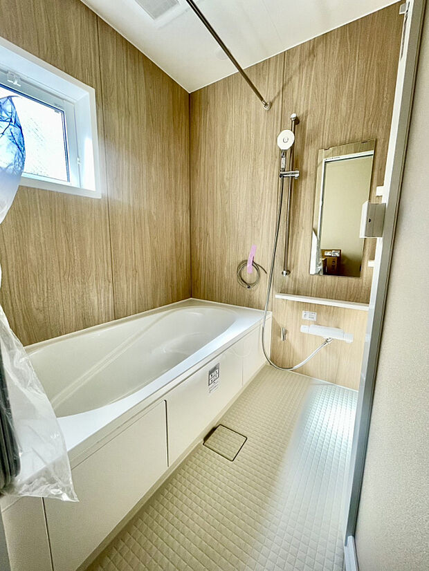 【2号棟:浴室】「木目パネルが映える、落ち着きあるバスルーム。」小窓付きで自然換気も可能。ゆったりとした浴槽で、一日の疲れをしっかり癒せます。