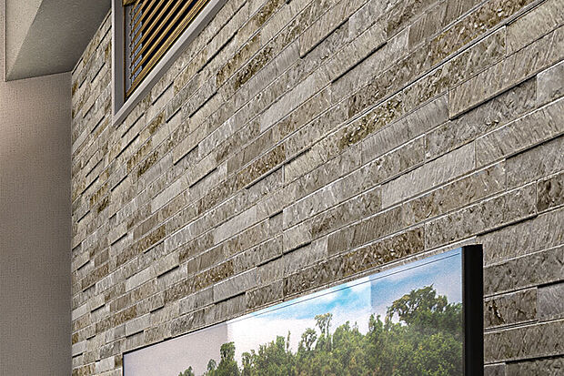 【グラビオエッジ フルッソ】
深い陰影が気品を添える石材調パネルをリビングの一部壁に採用しました。※カラーは号棟により異なります。