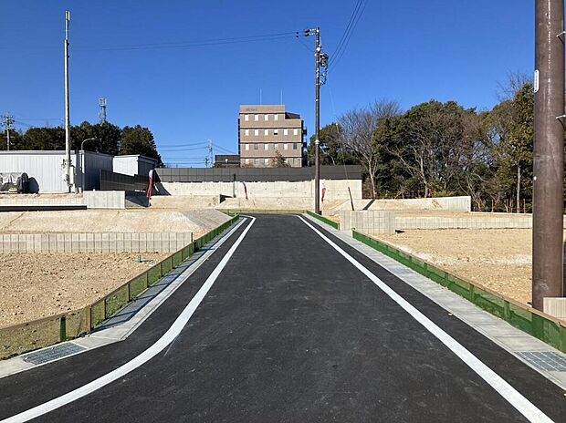 【前面道路（開発道路）】新しく整備された開発道路を囲む、統一感のある美しい街並み。空が広く感じられる開放的な開発道路が、全8区画の邸宅地にさらなる気品とゆとりを添え、住まう人の誇りを高めます。
