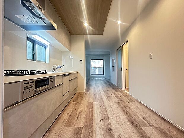 【【2階キッチン】】テレビなどが視界に入らず、お料理に集中できる壁付けキッチン。食器洗乾燥機や浄水器付き水栓を搭載しています。天井部分の木目が横方向に伸び、視覚的にもより広く感じられます。