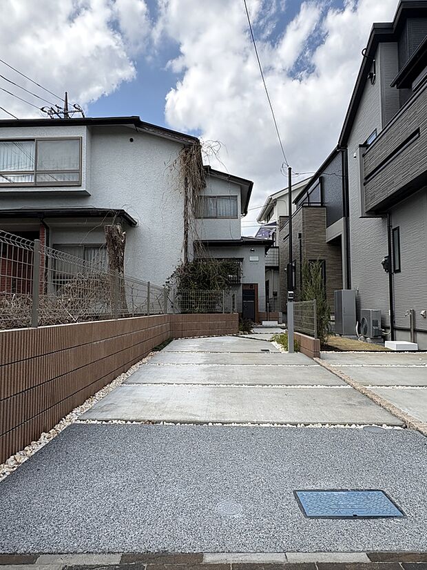 【【現地外観写真】】アプローチ部分に設けられた駐車スペースです。EVコンセント(200V用)が備わっており、電気自動車にも対応しています。