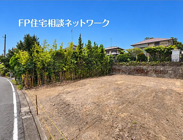 【現地土地写真】採光をたっぷり取り込める、陽当りの良い分譲地です。前面道路に沿って間口が広く、開放感があります。隣地との境界には豊かな緑の植栽が施されており、自然を感じられる穏やかな住環境です。
