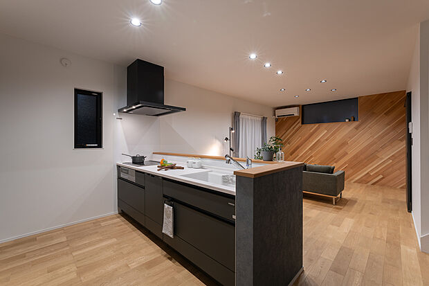 【キッチン】キッチン|オープンではあるものの、少し壁を立ち上げ手元は隠せるように。キッチンからLDを見渡せる事で、空間としての繋がりを。コンロ奥の扉は1.5畳のキッチンパントリー。