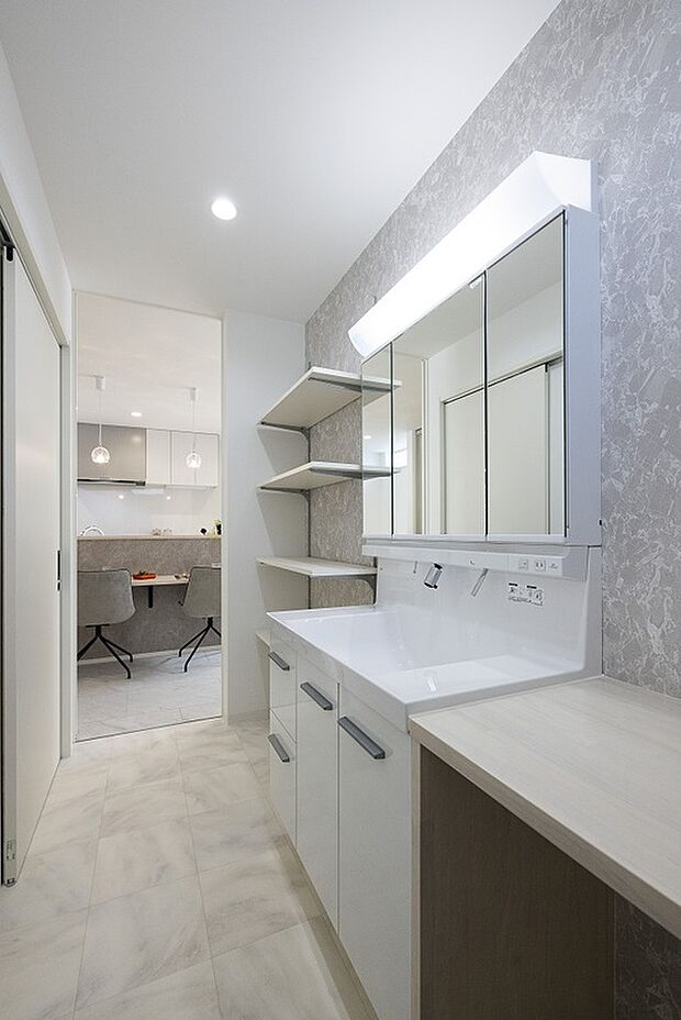 【【1階洗面所/当社施工例】】洗面所はキッチン近くに配置し、水回りを集めることで動線をつなぎ、家事効率UP!洗面化粧台は、お手入れがしやすい壁付け水栓タイプ。横並びのカウンターはパウダースペースやアイロン掛けなどに。/建物価格2761.1万円、建物面積96.47m2、3LDK