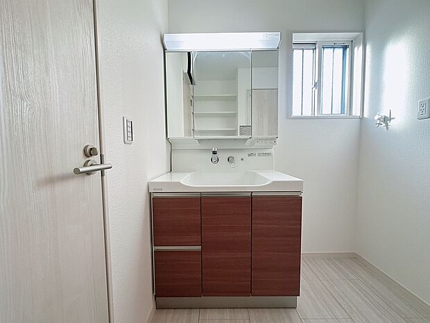 【【6号棟:洗面台】】ボウルとの一体型成形で継ぎ目のないハイバックガードと壁出し水栓は、汚れがたまりにくく、毎日のお手入れが簡単です。濡れたままのコップを収納できる棚など収納も充実。(2026年1月26日撮影)