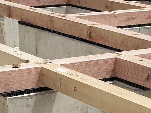 【剛性・耐久性にすぐれた「ベタ基礎」】コンクリートで建物の下一面を支える工法。基礎鉄筋を張り、強度を高めたベタ基礎の耐圧盤を1階の床下全面に施工し、広い耐圧盤の面で建物の荷重を地盤に伝えます。