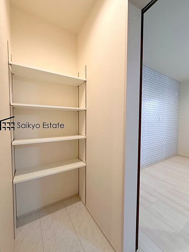 【パントリー（施工例）】システムキッチンのすぐそばに配置したパントリー。ストック食品や調味料やお酒のほか、非常食や水のペットボトルなどの防災用品も収納できます。