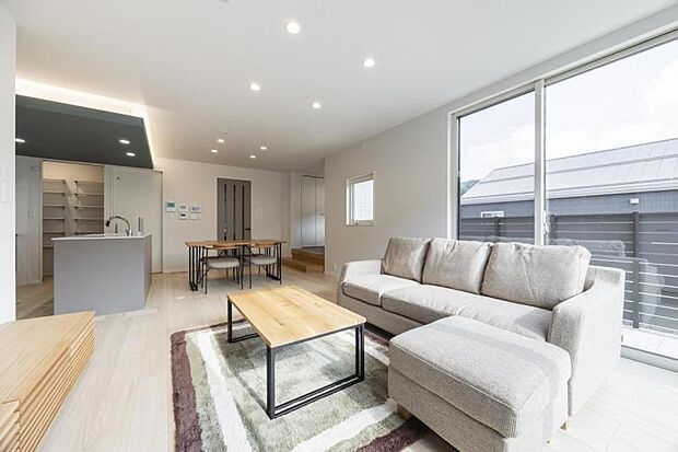 リビング【8号地】(2024年11月撮影)コーナーに配した大開口を通じて外のテラスへ視線が繋がり、開放感を感じさせます。