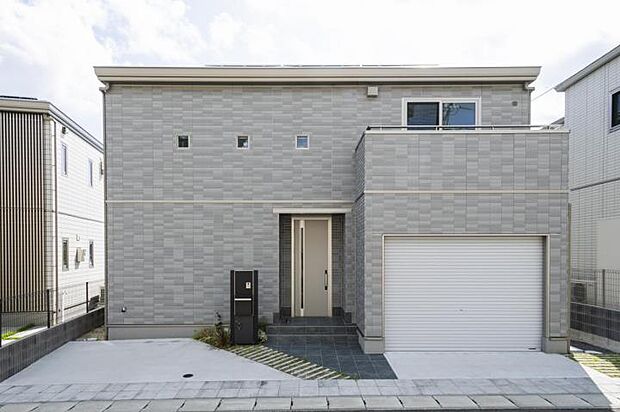 【外観【26号地】(2025年7月撮影)】明るみのあるグレーを基調とした長く美しさを保つ「タイル外壁」。防犯、災害に強いシャッター付インナーガレージ。