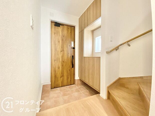 【玄関】外観に調和したデザインの玄関は、温かみのある雰囲気を醸し出します。美しいドアとシンプルなラインが、家の印象を引き立て、来客を迎えるにふさわしい洗練された空間で、心地よい第一印象を与えます。