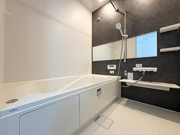 【浴室】LIXIL製のシックな浴室。ワイドミラーが空間を広く見せ、一日の疲れを癒やす贅沢なバスタイムをお楽しみいただけます。