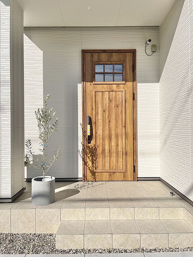 【（No.4）玄関】可愛らしい玄関ドア。白の外壁と相性が良いです。オリーブの植栽で緑も加わりテンションの上がる玄関です。