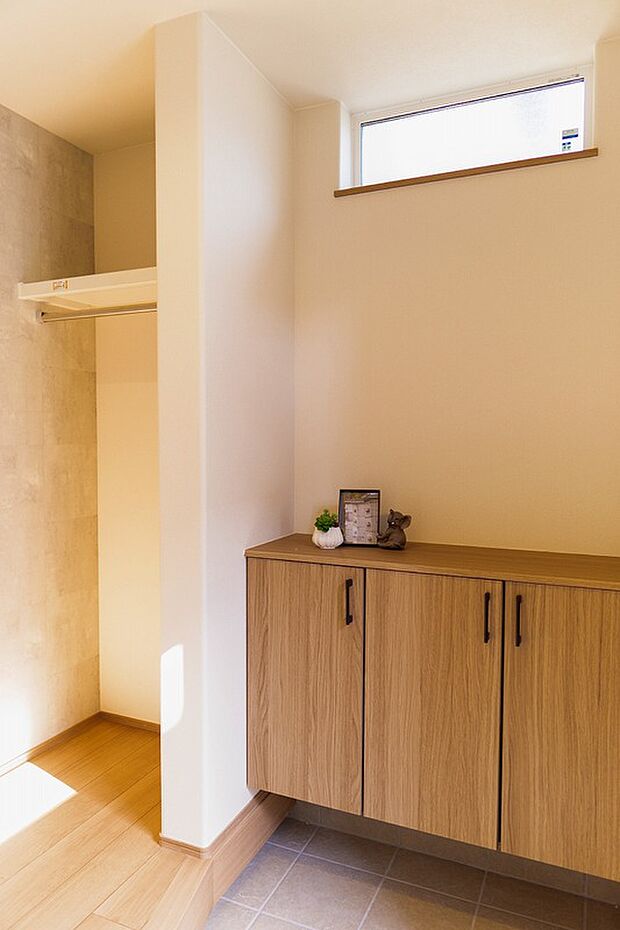 【玄関】高窓から光が差し込む明るい玄関。木製収納がナチュラルな空間を演出します。