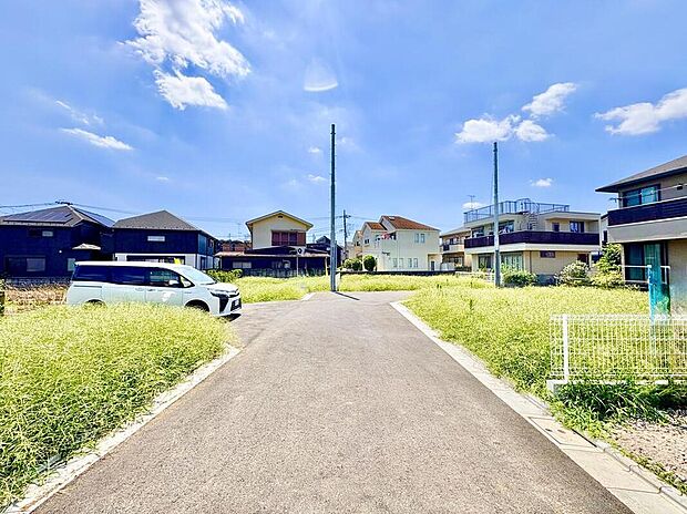 青空が広がる穏やかな住宅街。この道は、家族の笑顔と新しい思い出を育む場所へと繋がります。