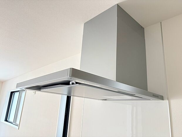 【レンジフード】キッチン空間をすっきりと見せるスタイリッシュなレンジフード。調理中の煙やニオイを効率よく排出し、快適で清潔なキッチン環境をサポートします。毎日の料理をより心地よく楽しめる、機能性にも配慮した設備です。