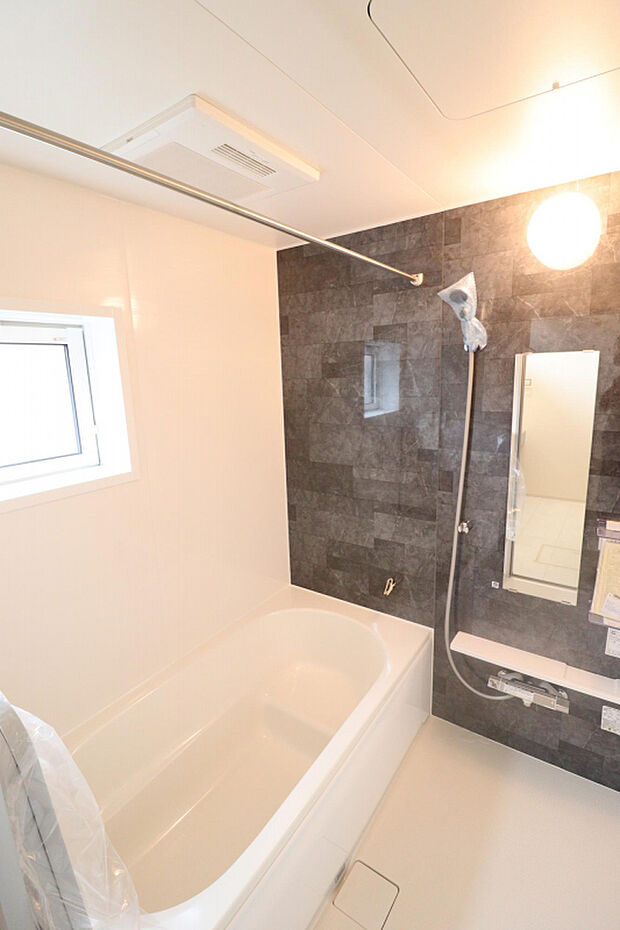 【【浴室】】トーンを抑えたアクセントパネルで落ち着きのあるバスルームを演出。浴室乾燥機を搭載しており、悪天候の日や花粉の飛散量が増える時期などの衣類干しも可能です。
