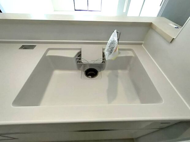 【シンクスペース(1号棟)】人造大理石のシンクは、高級感ある見た目と汚れに強い素材で、毎日の掃除も簡単。継ぎ目の少ない一体型設計で清潔感も抜群。キッチン全体の印象を引き締める美しい仕上がりです♪