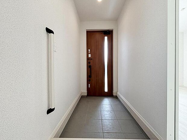 【玄関】【１号棟】明るくて清潔感溢れる玄関。手すり付きで靴の脱ぎ履きも安心です。