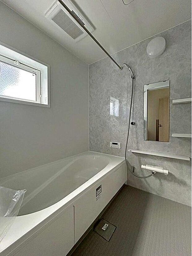 【浴室】１号棟
アクセントパネルで落ち着きのある雰囲気を演出したバスルーム♪毎日の疲れを癒やすバスタイムをお楽しみ下さい！浴室換気乾燥暖房機付きで、ジメジメした季節や雨の日には、浴室内干しも可能！