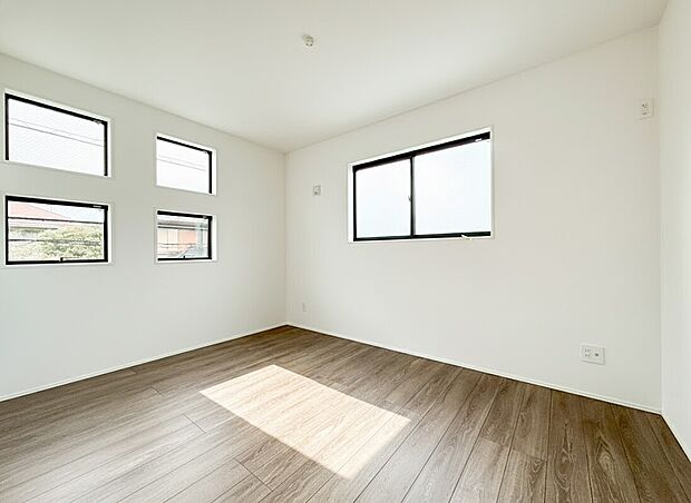 【居室】明るい陽光がたっぷりと差し込む、開放感あふれる2面採光の居室です。白を基調とした壁面と温かみのある木目調のフローリングが、どんなインテリアとも相性の良いクリーンで心地よい空間を演出します。