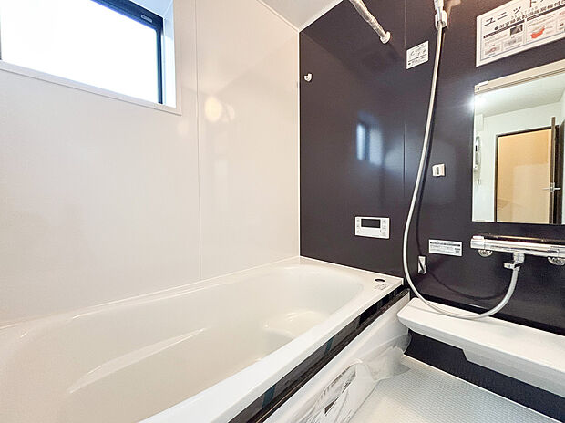 【ユニットバス】シックなダークカラーのアクセントパネルが落ち着いた空間を演出する、機能的なシステムバスです 。ゆったりと足を伸ばせる浴槽には、半身浴も楽しめるステップを完備 。