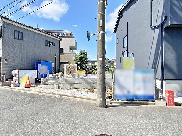 【現地外観写真】現地(2026年8月)撮影
工事中の敷地と南側約6m公道に面した外観写真です。土地面積102.84m2、木造2階建・建物面積102.05m2、駐車場2台、葛西駅徒歩12分、価格10,390万円。