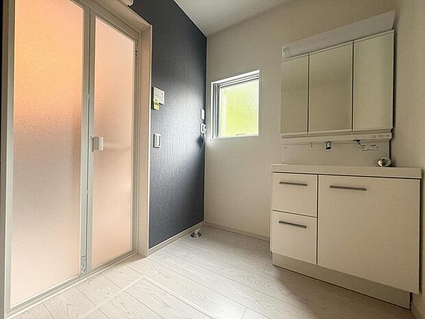 清潔感あふれる洗面台で、忙しい朝の身支度スムーズに。豊富な収納で家族のアイテムすっきり。明るい小窓が心地よい空間です。