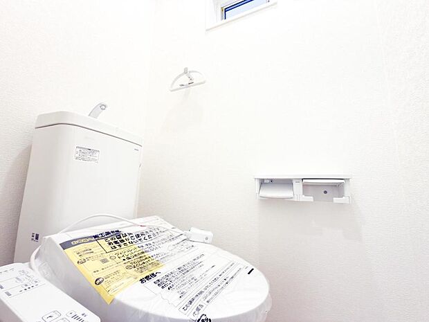 白を基調とした清潔感あふれるトイレは、ウォシュレット機能付きでいつでも快適。上部の手洗い器も便利で、家族みんなが気持ちよく使えるプライベート空間です。