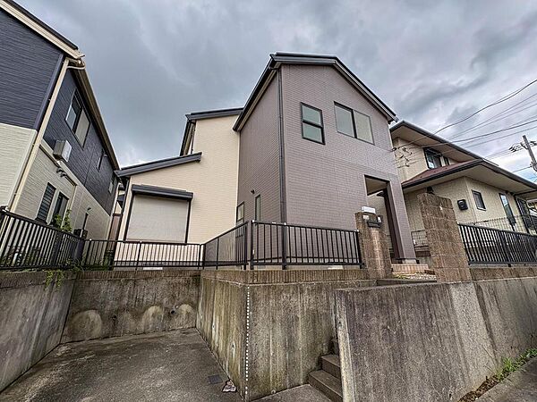 落ち着いた色合いの外壁が、洗練された印象を与える住まいです。高台に位置し、プライバシーも確保。家族の笑顔が育まれる、安心感のある暮らしがここから始まります。
