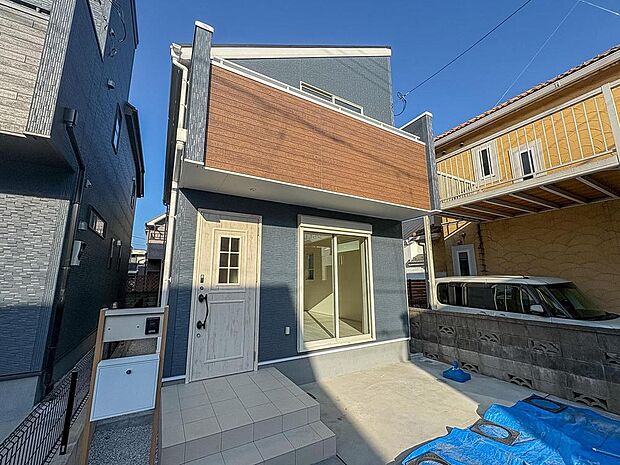 青と木目のコントラストが美しい、洗練された外観デザイン。新しい家族の思い出を育む、明るく開放的な住まいがここにあります。