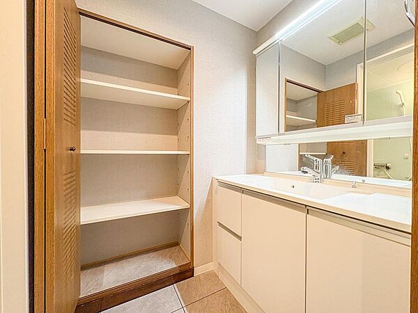 広々とした洗面台は朝の身支度もスムーズに。鏡裏収納や隣の棚でタオルや洗剤もすっきり片付き、家族みんなで快適に使えます。