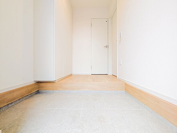 人感センサー付き照明で、帰宅した瞬間明るい玄関が迎え入れてくれます。壁一面の収納が、家族全員の靴をすっきり納めます。