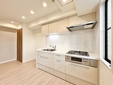 キッチンは作業がしやすい壁付けタイプです。吊戸棚やキッチン下部に収納が設けられています。
