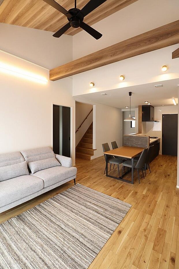 勾配天井で広々としたリビング。当社コーディネーターが選定した家具やカーテンも付いています。