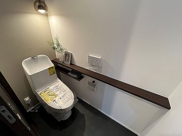1Fトイレ。落ち着いた雰囲気のトイレです。トイレットペーパーの予備もおけますよ。
