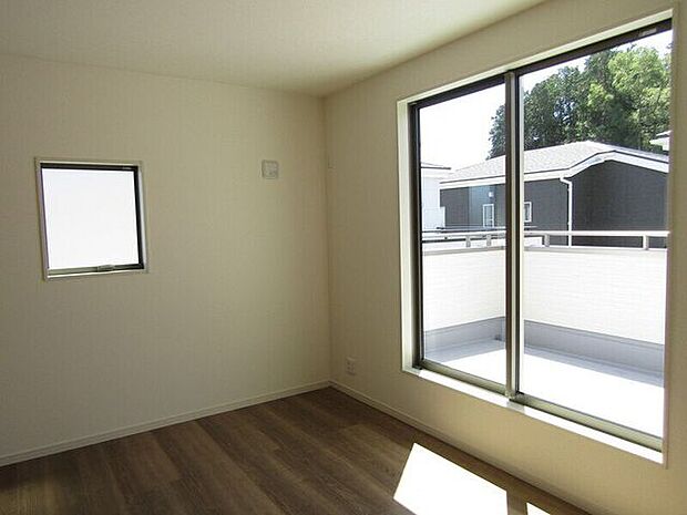 大きな窓からたっぷりと自然光が差し込む明るい洋室。バルコニーへの出入りもスムーズです。