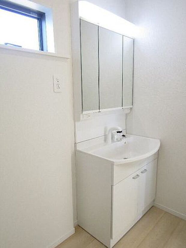 シャワー水栓で、洗髪やお掃除もスムーズ。三面鏡の裏にはたっぷり収納スペースがあり、洗面まわりの小物をすっきり整理できます。毎日の身支度が快適になる、機能的な洗面化粧台です。