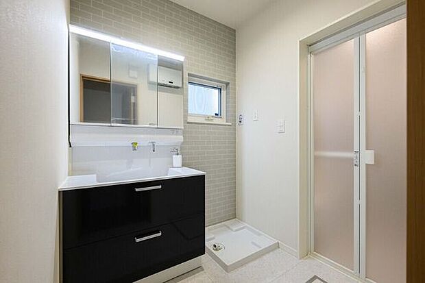 三面鏡の洗面化粧台は鏡扉の裏収納でたっぷりの容量をスッキリと収納できます。シャワーヘッド付きでお掃除も楽ちんです。