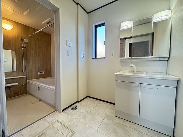 【洗面室/C号棟】洗面化粧台と浴室の間に洗濯機置場が設けられています。予洗い後の洗濯物をスムーズに移動でき便利です。