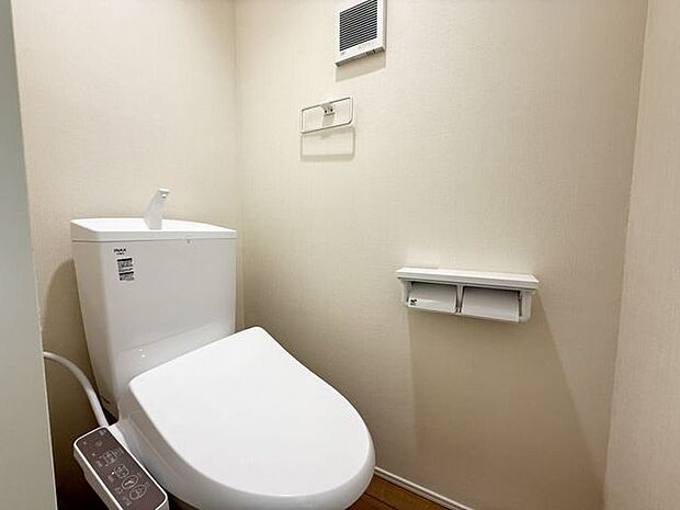 【2階トイレ/1号棟】タオル掛けと、2連のペーパーホルダーなどが設置されています。