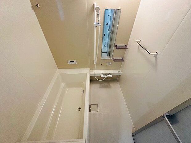 【浴室/1号棟】ゆったりとしたバスタブに足を伸ばし、一日の疲れを癒すことができます。シャワーの高さ調節ができるスライドバーが備わっています。