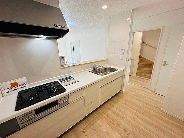 【キッチン/1号棟】対面式キッチンからLD全体を見渡せる設計。立ったまま使えて、奥の物も出し入れしやすいスライドタイプの収納が備わったキッチンです。