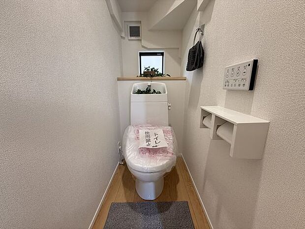 【トイレ/1階/2号棟】年間を通して快適に使用できる温水洗浄便座付き。窓があるため、使用後や掃除の際など、自然換気が行えます。※家具調度品等は販売価格に含まれません。
