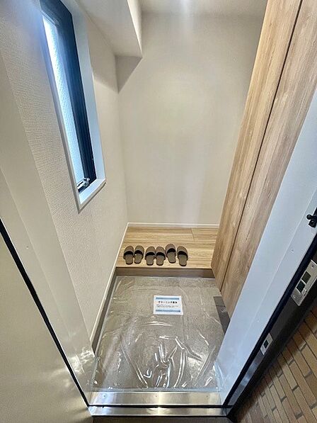 窓のある明るい玄関スペース。ドアを開けたらシューズボックス、使いやすい配置です。