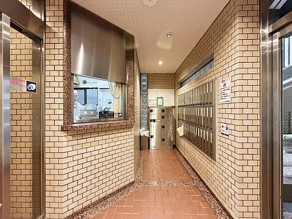 【エントランス】外の喧騒を忘れさせる、落ち着いたタイル貼りのモダンな空間。
