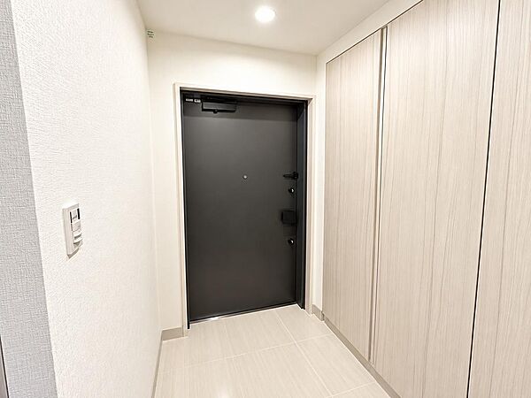明るくすっきりとした玄関スペース。住戸内の落ち着いた内装と調和した、清潔感のある空間です。
