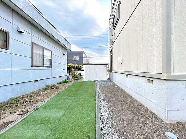 【庭】南東側の庭の写真です。奥に見えるのは車庫の裏面です。車庫を撤去して縦列2台の駐車場にリフォームするのもありですね。
