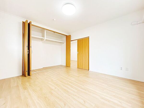 【洋室8帖別角度】令和5年に床材張替、クロス張替、建具交換を実施しております。クローゼット内には枕棚とハンガーパイプが設置されており、衣類等の収納に便利です。