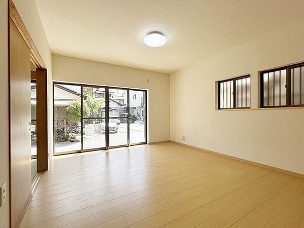 【リフォーム済】約14帖のリビングはフローリング重ね張り、床天井のクロス張替えを行いました。南側から日が入る明るい雰囲気のお部屋です。